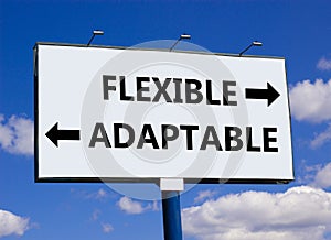 Flexible or adaptable symbol. Concept word Flexible Adaptable on beautiful billboard with two arrows. Beautiful blue sky with