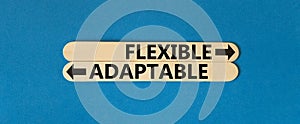 Flexible or adaptable symbol. Concept word Flexible Adaptable on beautiful wooden stick. Beautiful blue table blue background.