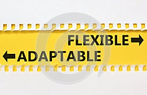 Flexible or adaptable symbol. Concept word Flexible Adaptable on beautiful yellow paper. Beautiful white paper background.