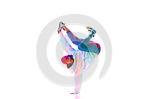 Flexible, artistic young man, hip hop, breakdancer in motion, performing isolated over white studio background in neon