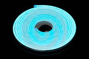 Flexible blue led tape neon flex in roll on black background