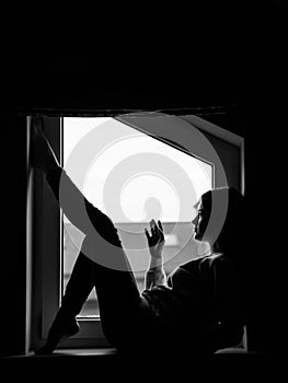 Flexible body of a young girl plastically placed in the window.