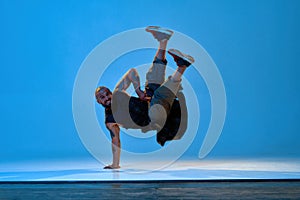 Flexible caucasian male dancer dancing break dance