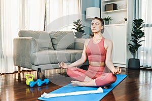 Flexible and dexterity woman in sportswear doing reverse gaiety yoga position