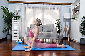 Flexible and dexterity woman in sportswear doing reverse gaiety yoga position