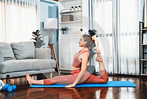 Flexible and dexterity woman in sportswear doing reverse gaiety yoga position