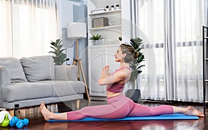 Flexible and dexterity woman in sportswear doing reverse gaiety yoga position