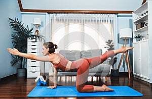 Flexible and dexterity woman in sportswear doing reverse gaiety yoga position