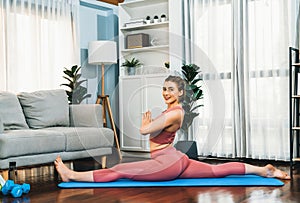 Flexible and dexterity woman in sportswear doing reverse gaiety yoga position