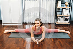 Flexible and dexterity woman in sportswear doing reverse gaiety yoga position