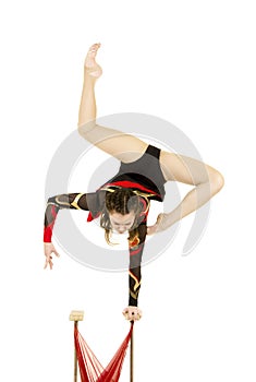 Flexible equilibrist performs exercises on acrobatic walking sticks