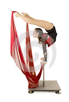 Flexible equilibrist performs exercises on acrobatic walking sticks