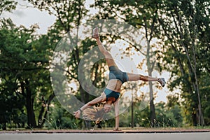 Flexible Female Athlete Show Impressive Cartwheel Skills Outdoors