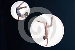 Flexible girl and man doing stretching and handstand in studio. Concept of individuality, creativity and self-confidence