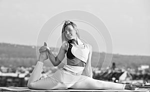 Flexible girl outdoor. Attractive woman practicing yoga. Splits exercise. Workout for gymnastic split. Stretching