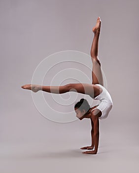 A flexible girl stands on her hands