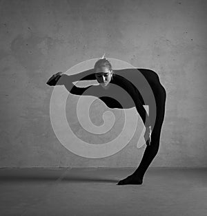 Flexible gymnast posing in black clothes