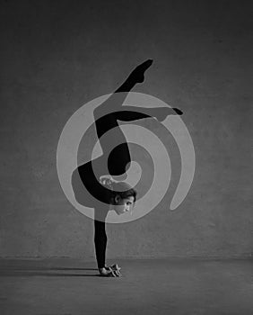 Flexible gymnast posing in black clothes