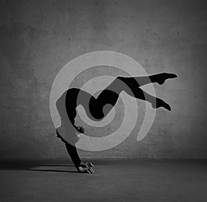 Flexible gymnast posing in black clothes