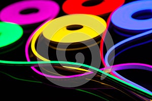 Flexible led tape neon flex in different colors on black background