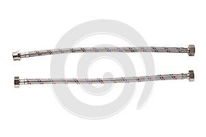 Flexible liner for water supply on a white background. Close-up of flexible metal braided hose