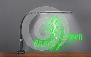 Flexible modern table LED Light shines on a drawn green electric bolt