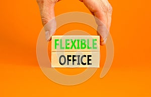 Flexible office symbol. Concept words Flexible office on beautiful wooden block. Beautiful orange paper background. Businessman