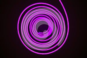 Flexible purple led tape neon flex in roll on black background