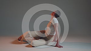 Flexible sexy young girl dancing on floor, performing contemporary passionate vogue dance to music. ProRes codec