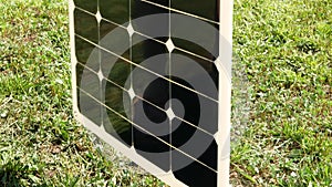 The flexible solar panel is rotated around the axis to show the thickness