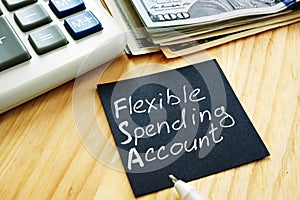 Flexible spending account FSA sign on a black piece of paper