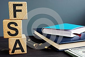 Flexible spending account FSA written on a wooden cubes