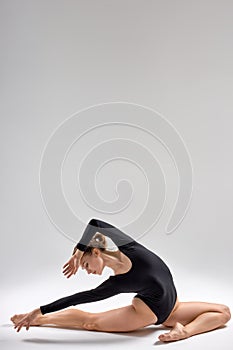 flexible talented dancer is doing exercises in ballet class