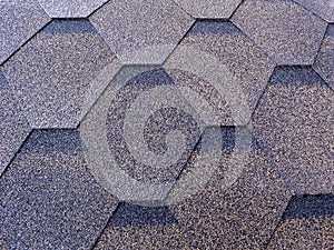 Flexible tiles with basalt granulate in the form of hexagons cover the entire surface of the background.