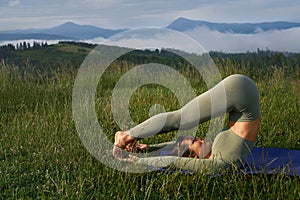 Flexible woman having physical activity on fresh air