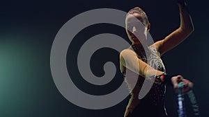 Flexible woman posing camera during performance hula hoop. Sportswoman training.