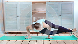 Flexible women practicing yoga standing on hand making balance full shot