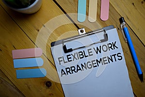 Flexible Work Arrangements write on a paperwork isolated on wooden background photo