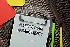 Flexible Work Arrangements write on a paperwork isolated on wooden background