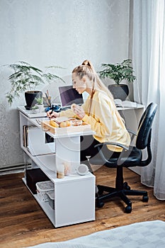 Flexible working, flexible work. Young woman freelancer working at home office with laptop and documents. Flexible work