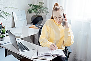 Flexible working, flexible work. Young woman freelancer working at home office with laptop and documents. Flexible work