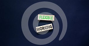 Flexible working symbol. Concept words Flexible working on beautiful wooden block. Beautiful black paper background. Business