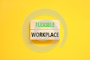 Flexible workplace symbol. Concept words Flexible workplace on beautiful wooden block. Beautiful yellow paper background. Business