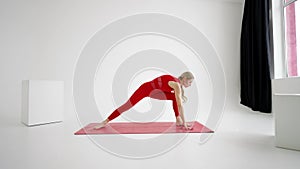 Flexible young fit girl practice yoga or pilates perform Wild Thing Pose for stretching and wellness. Yoga postures -