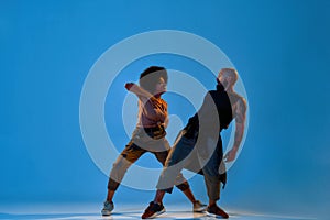 Flexible young man and woman dancing hip hop dance