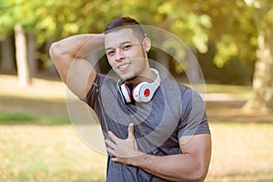 Flexing muscles posing runner young latin man running jogging sports training fitness workout