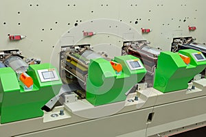 Flexographic printing press. Rotary / flexo press machine. In-line printing machine. Close-up shot of servo printing units photo
