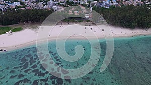 Flic en Flac Beach in Mauritius Island. Indian Ocean Coastline. Cloudy Sky and Mountain in Background