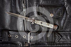 Flick knife on leather jacket photo