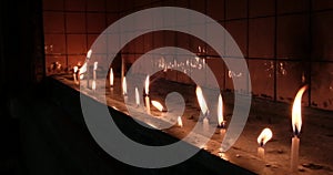 Flickering Prayer Candles in a Church - Side Angle View